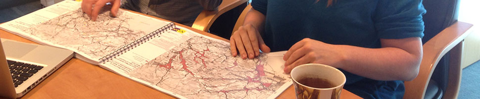 Photo of Vattenfall staff working with maps of physical sites